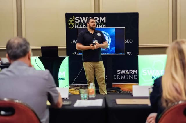 Marcus Scruggs presenting LTK on stage at the Swarm Pest Control Marketing mastermind