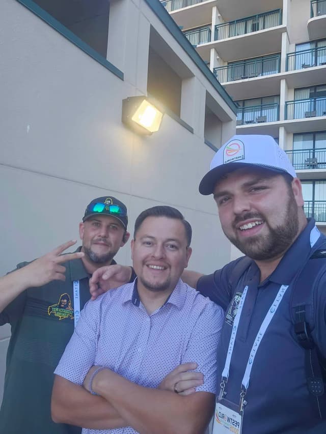 Three pest pros in PestWorld lanyards taking a selfie outside the convention hotel