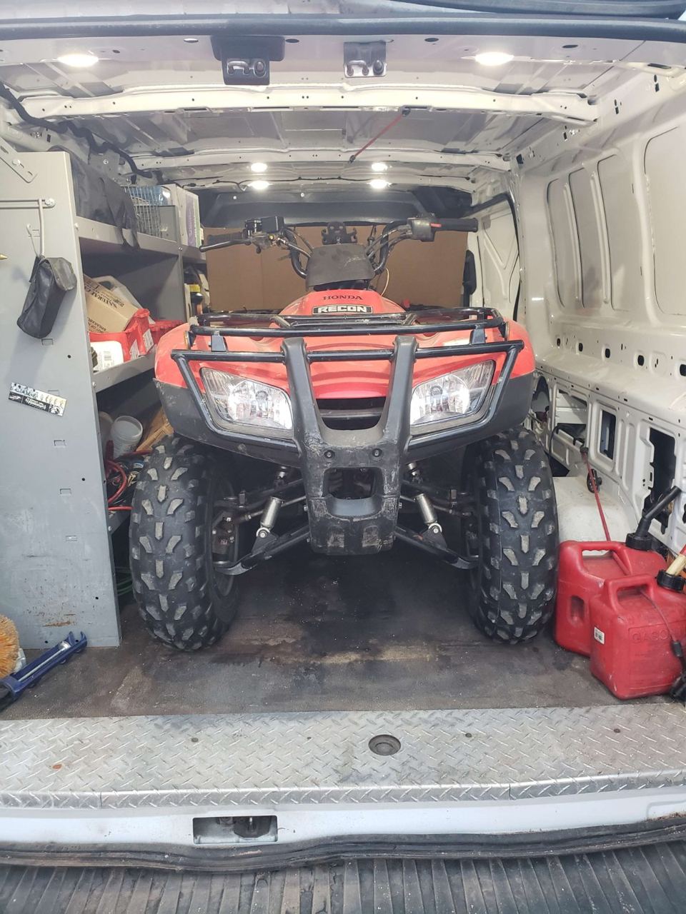 A work van loaded with an ATV and gear for a job